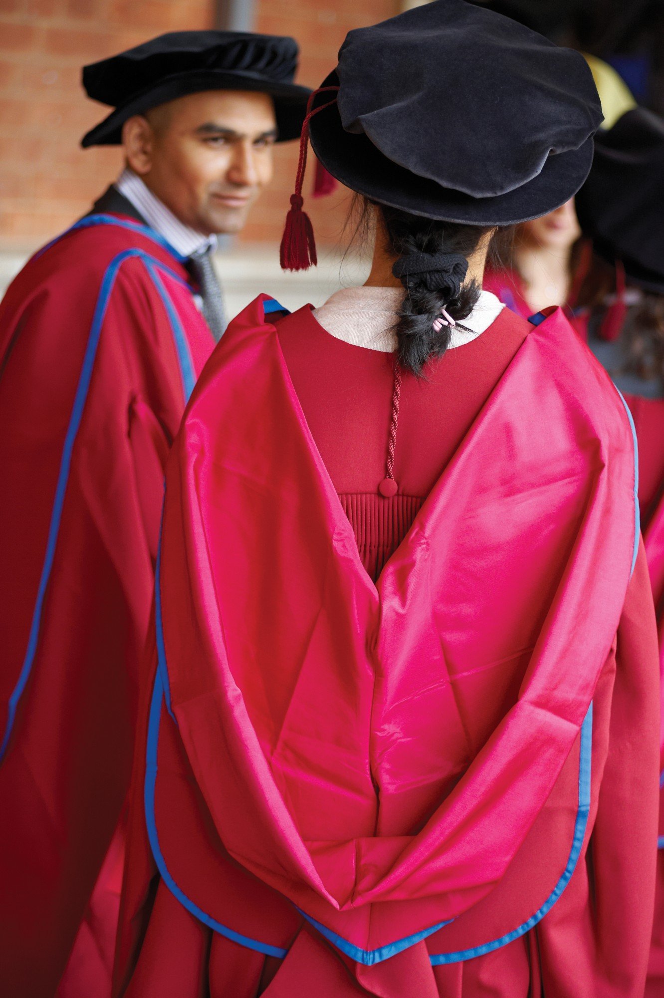 Postgraduates in red robes